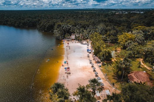 Stunning aerial shot of a beach on Laguna Quistococha, surrounded by lush forest in Iquitos, Peru.